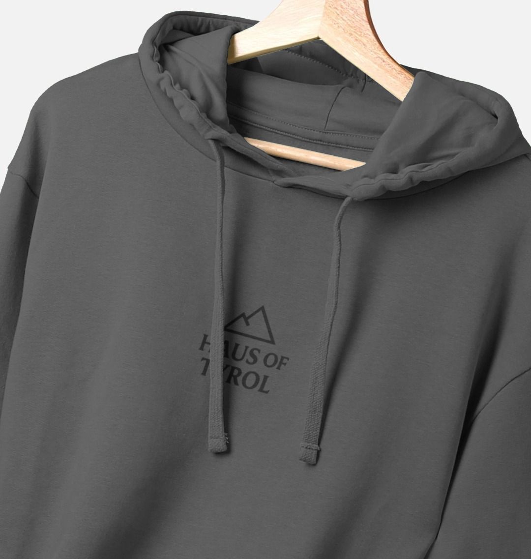 Dark Grey Sunset Hoodie close-up of chest logo on hanger